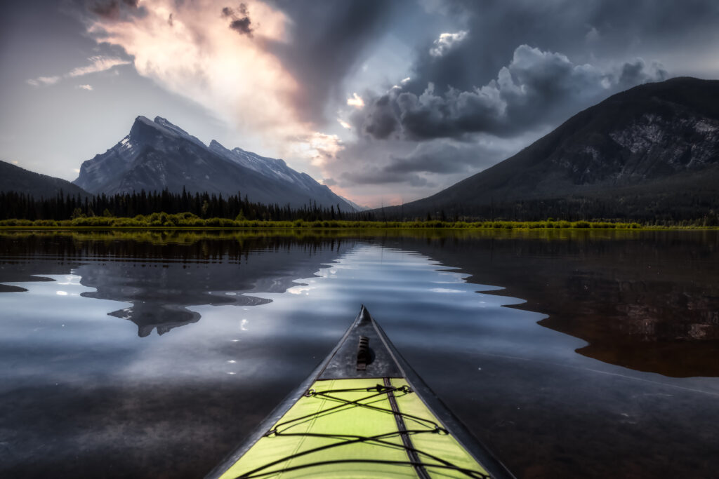 kayaking in a beautiful lake surrounded by the canadian mountain